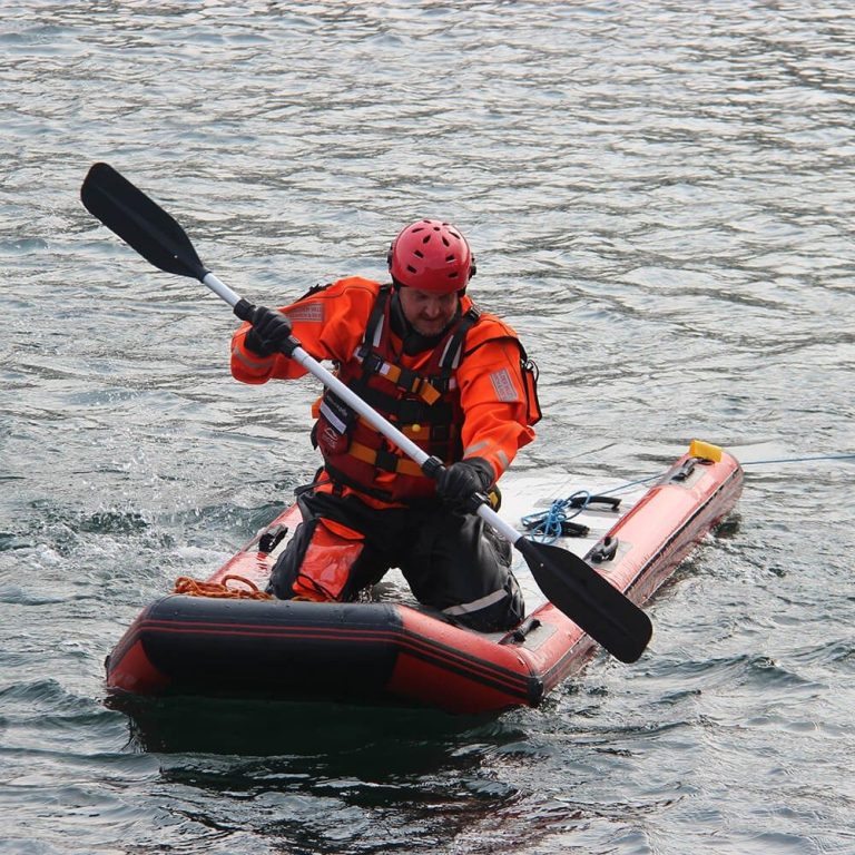 A person in Rescue Equipment kayaking with a paddle
