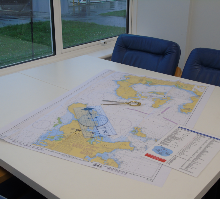 A table with a map and navigation equipment