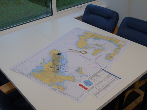 A table with a map and navigation equipment